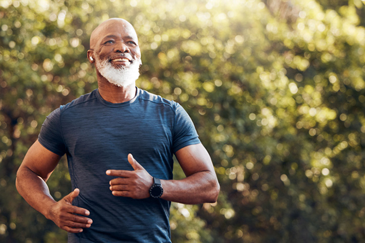 Older man jogging in park