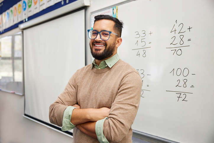 Male Standing in front of Whiteboard with mathematics